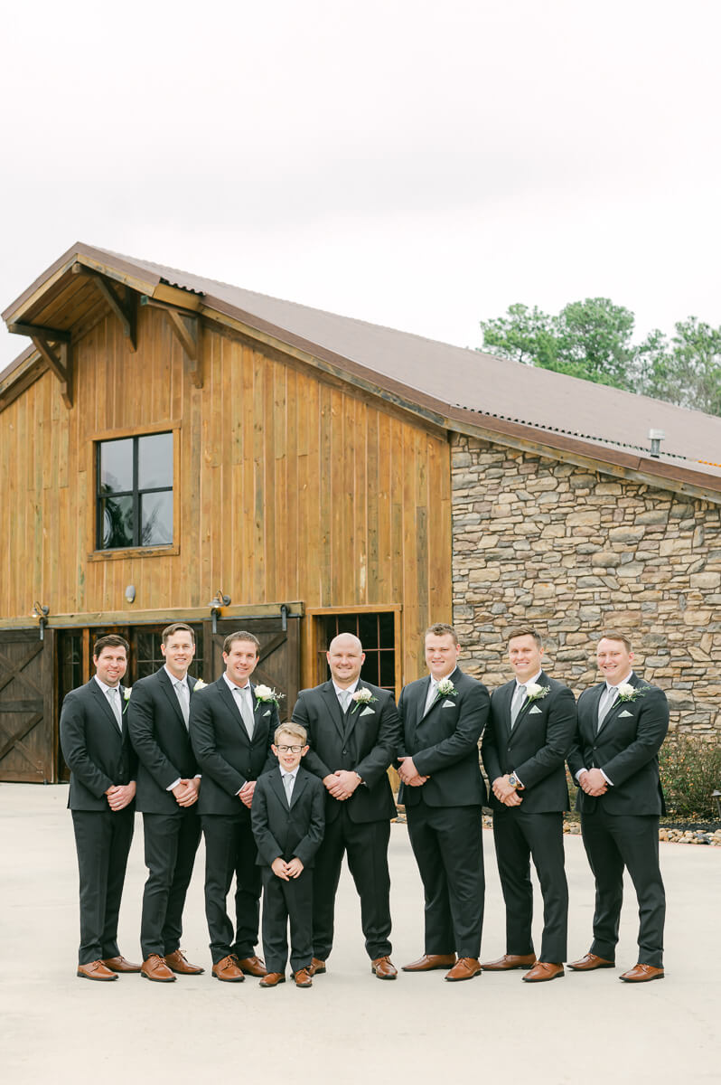 groomsmen in front of big sky barn