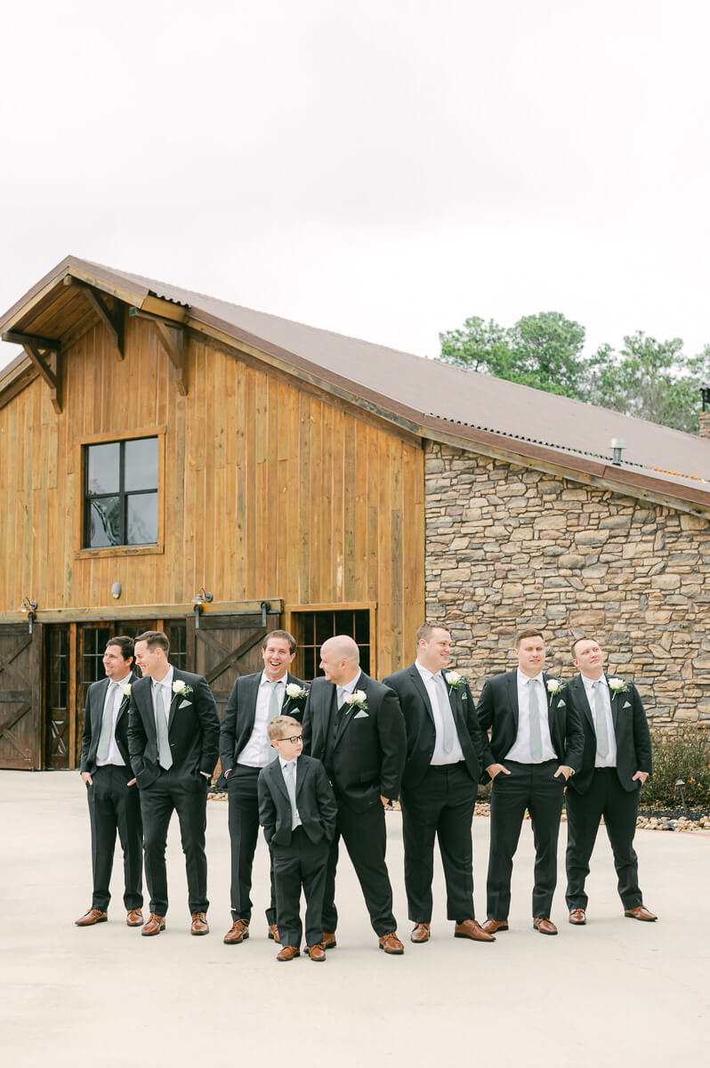 groomsmen in front of big sky barn