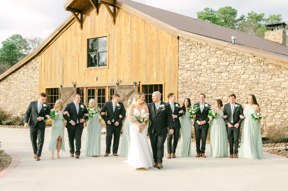 wedding party walking in front of wedding venue in Montgomery, Tx