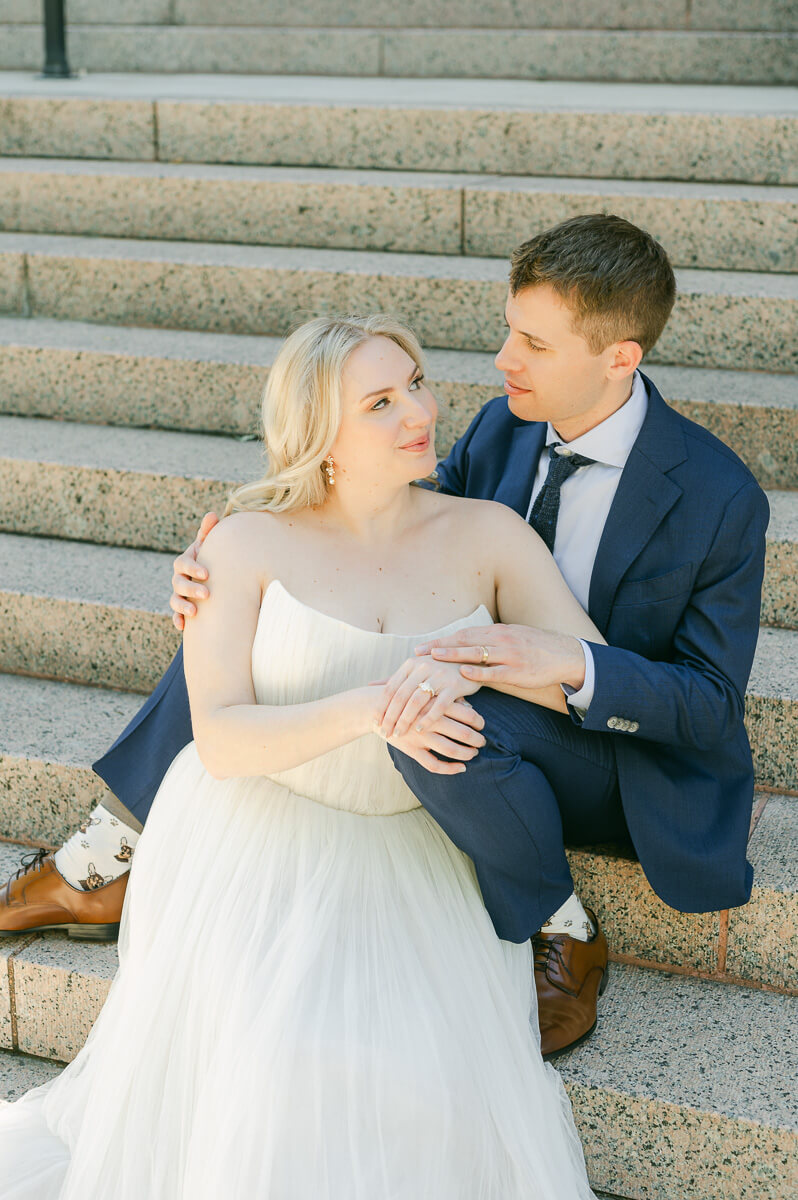 bride and groom posing on steps of downtown Houston historic courthouse