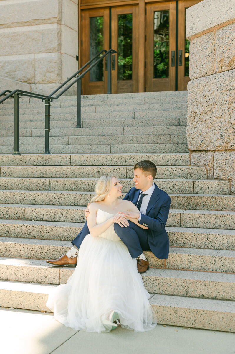 bride and groom posing on steps of downtown Houston historic courthouse