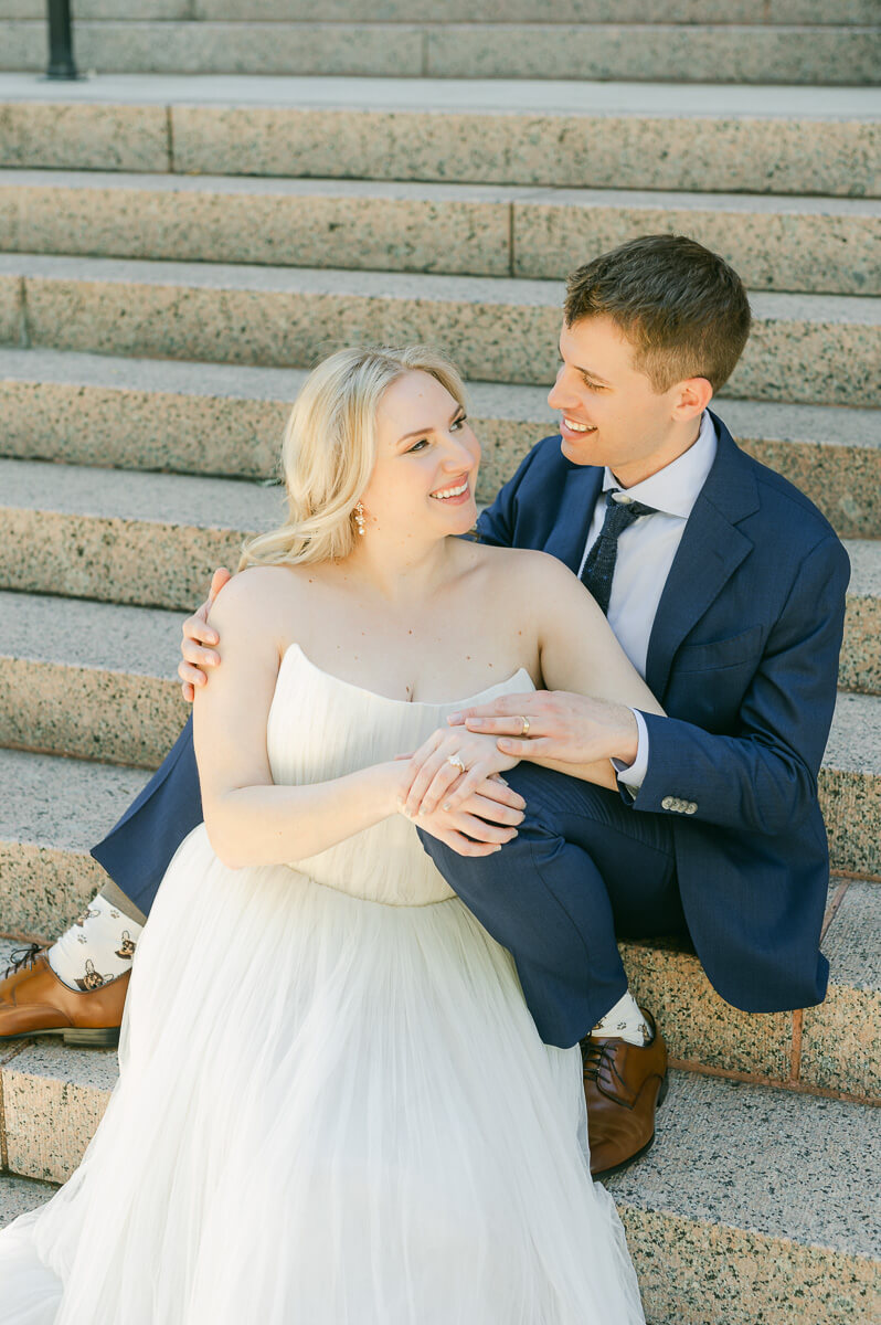 bride and groom posing on steps of downtown Houston historic courthouse