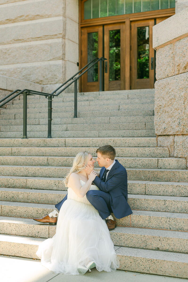 bride and groom posing on steps of downtown Houston historic courthouse