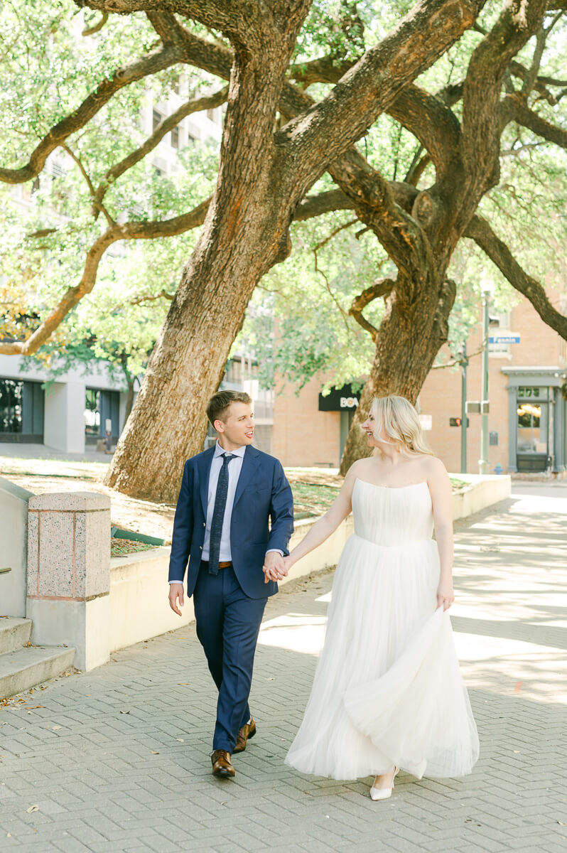 bride and groom walking in downtown Houston after their micro wedding