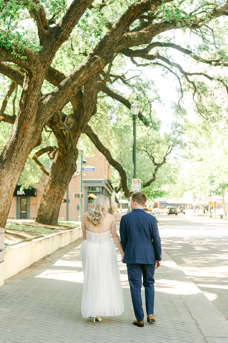 bride and groom walking in downtown Houston after their micro wedding