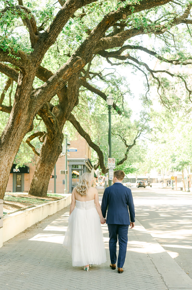 bride and groom walking in downtown Houston after their micro wedding