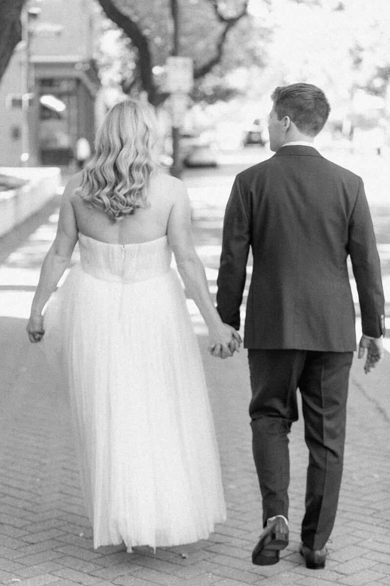 bride and groom walking in downtown Houston after their micro wedding