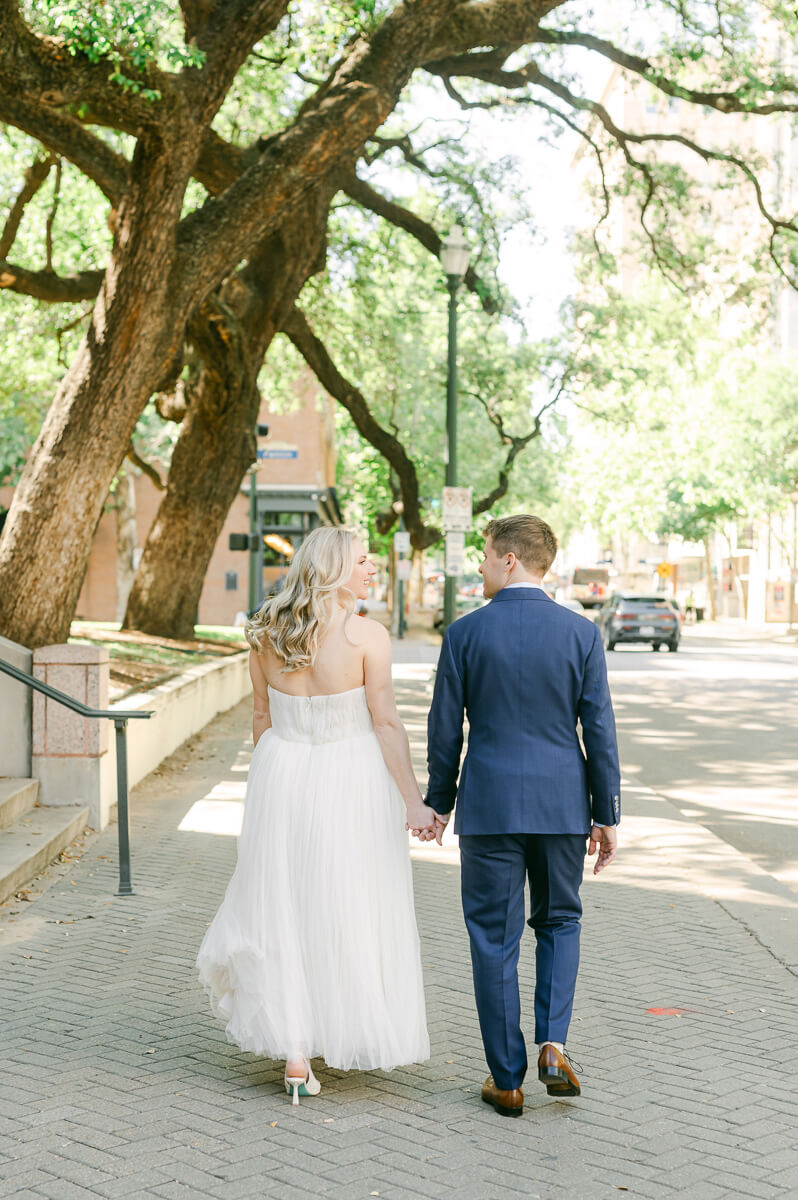bride and groom walking downtown