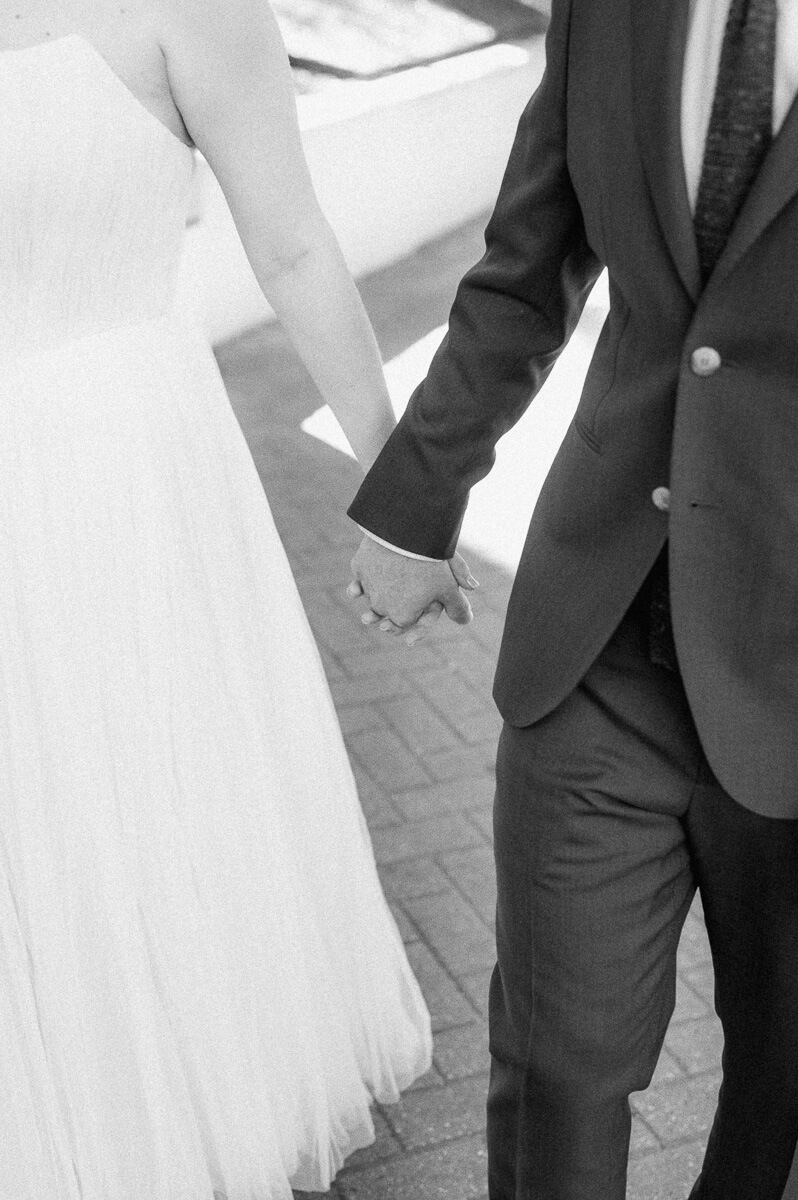 bride and groom walking downtown