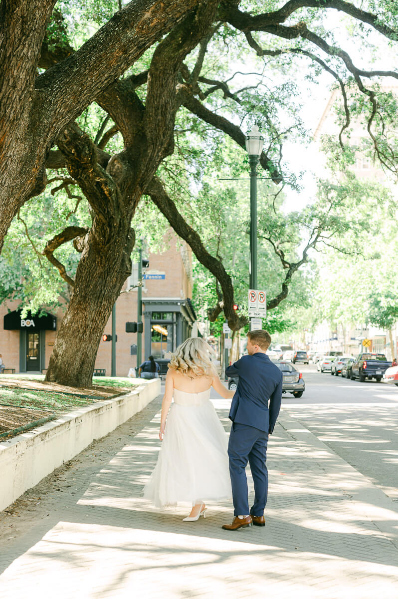 bride and groom walking downtown
