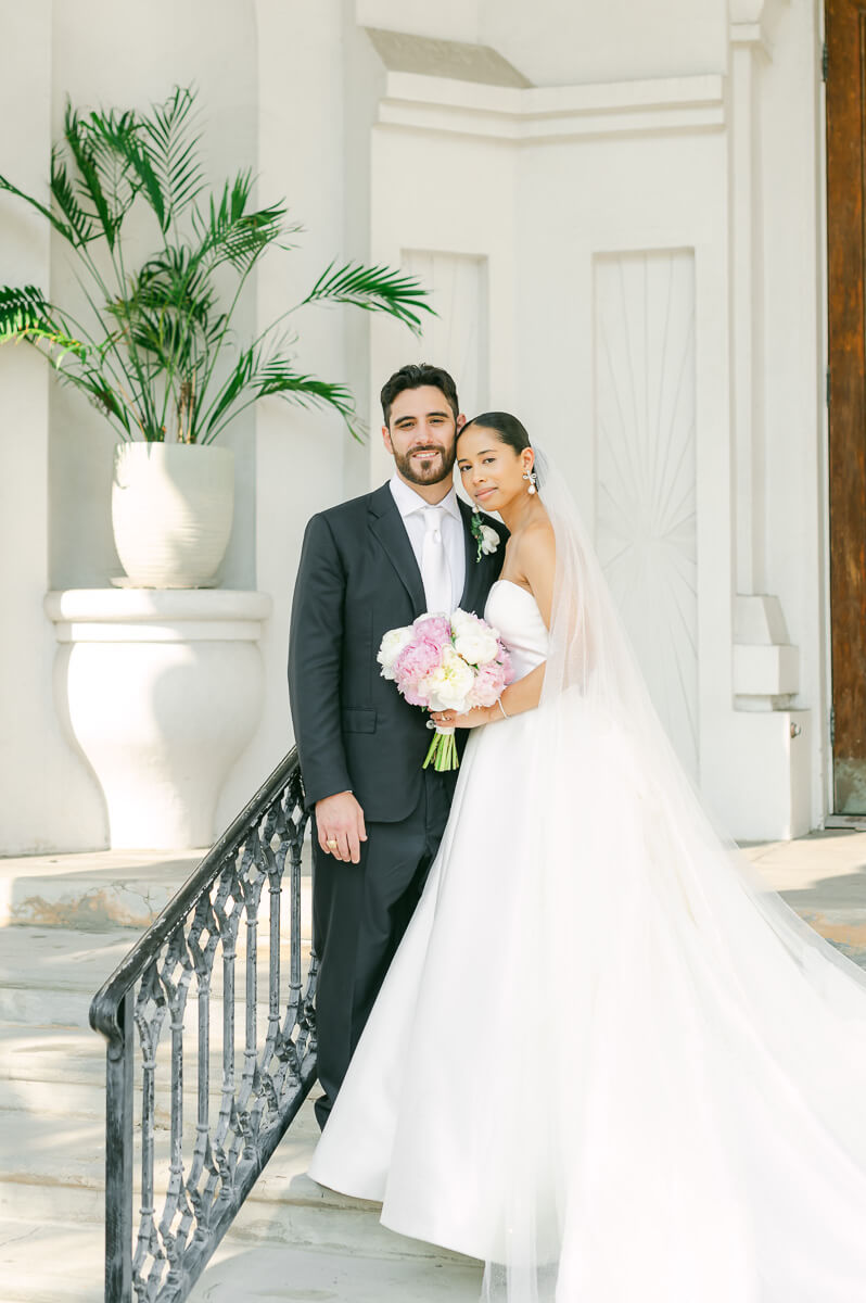 bride and groom posing for Galveston wedding photographer