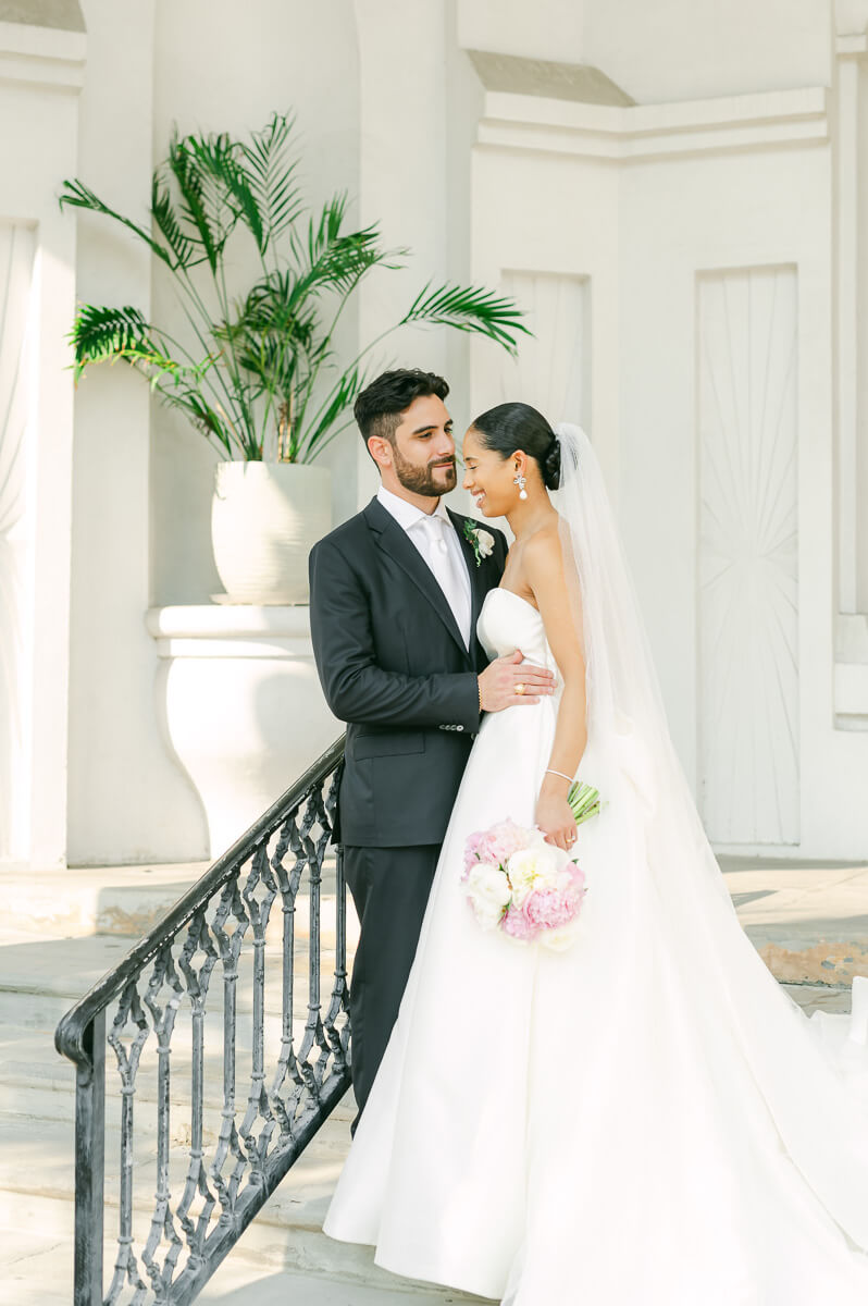 bride and groom posing for Galveston wedding photographer