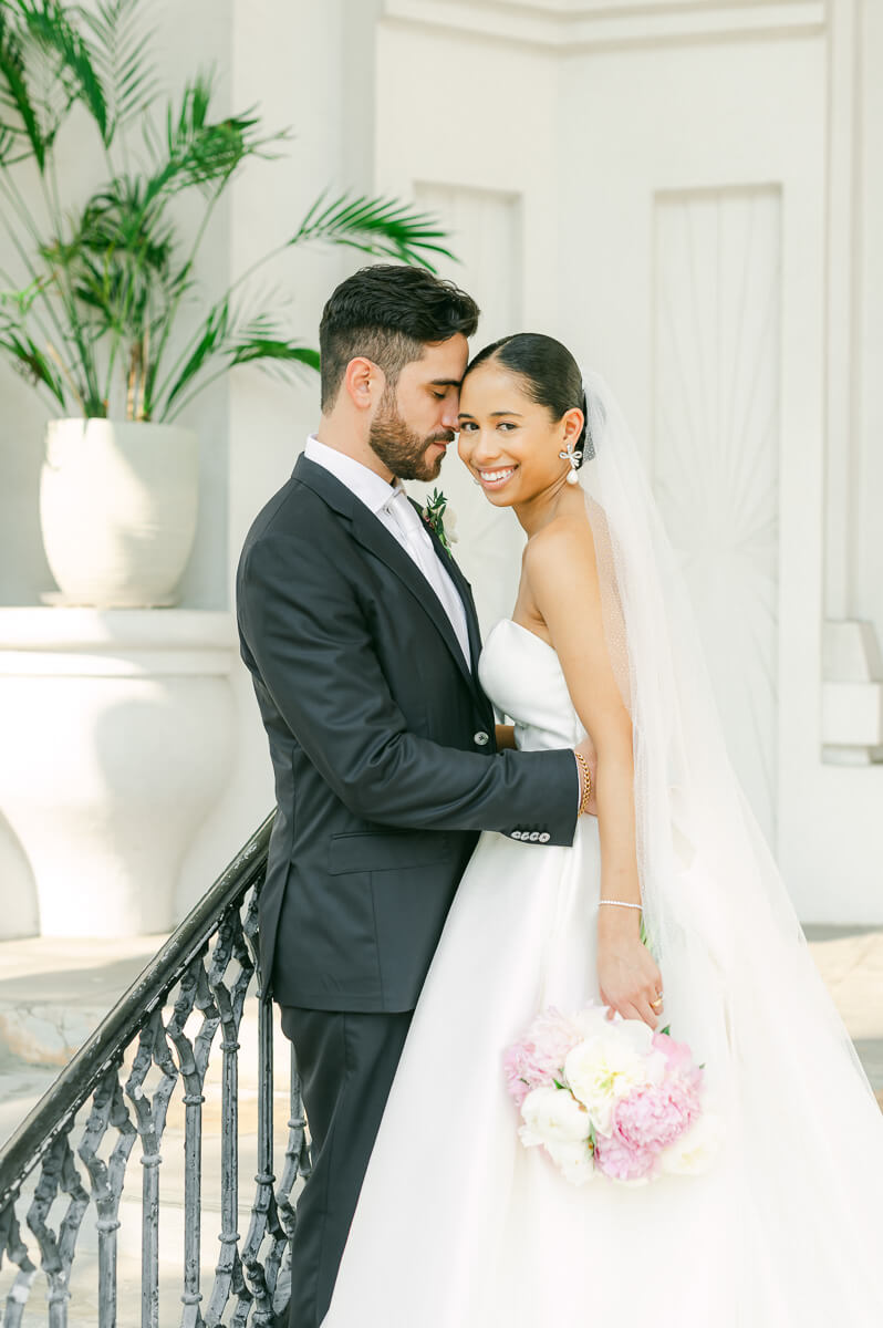 bride and groom posing for Galveston wedding photographer