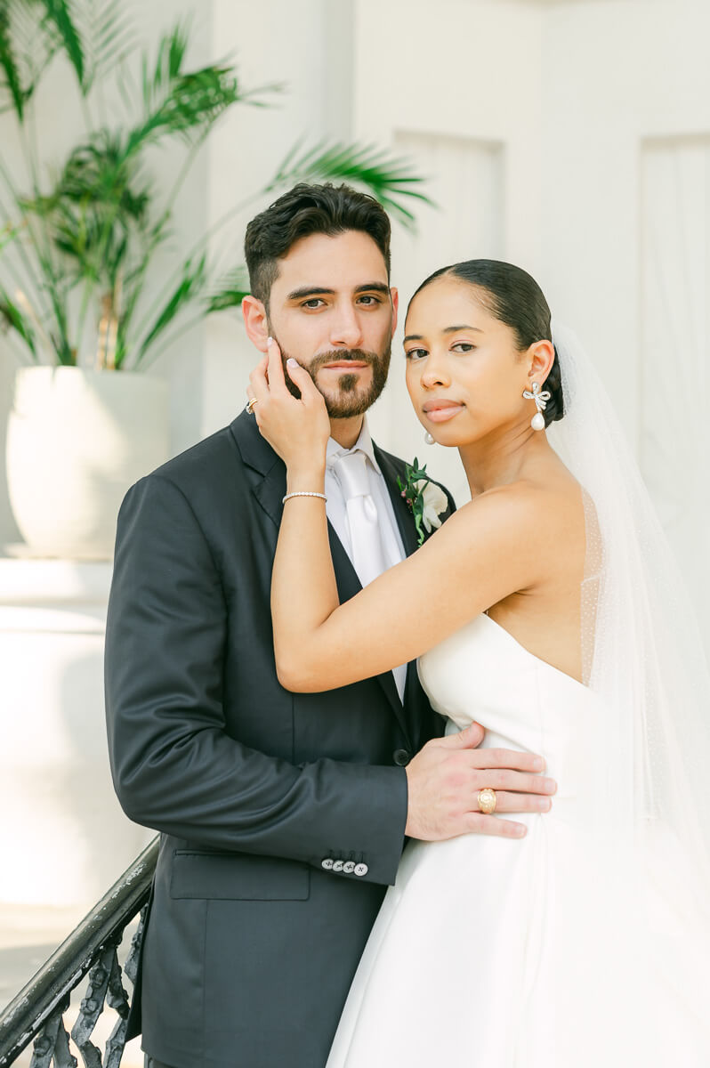 bride and groom posing for Galveston wedding photographer