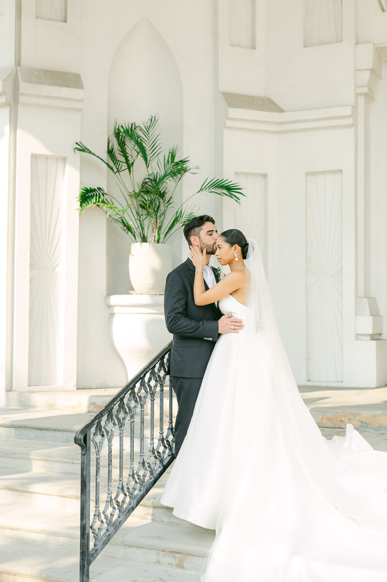 bride and groom posing for Galveston wedding photographer