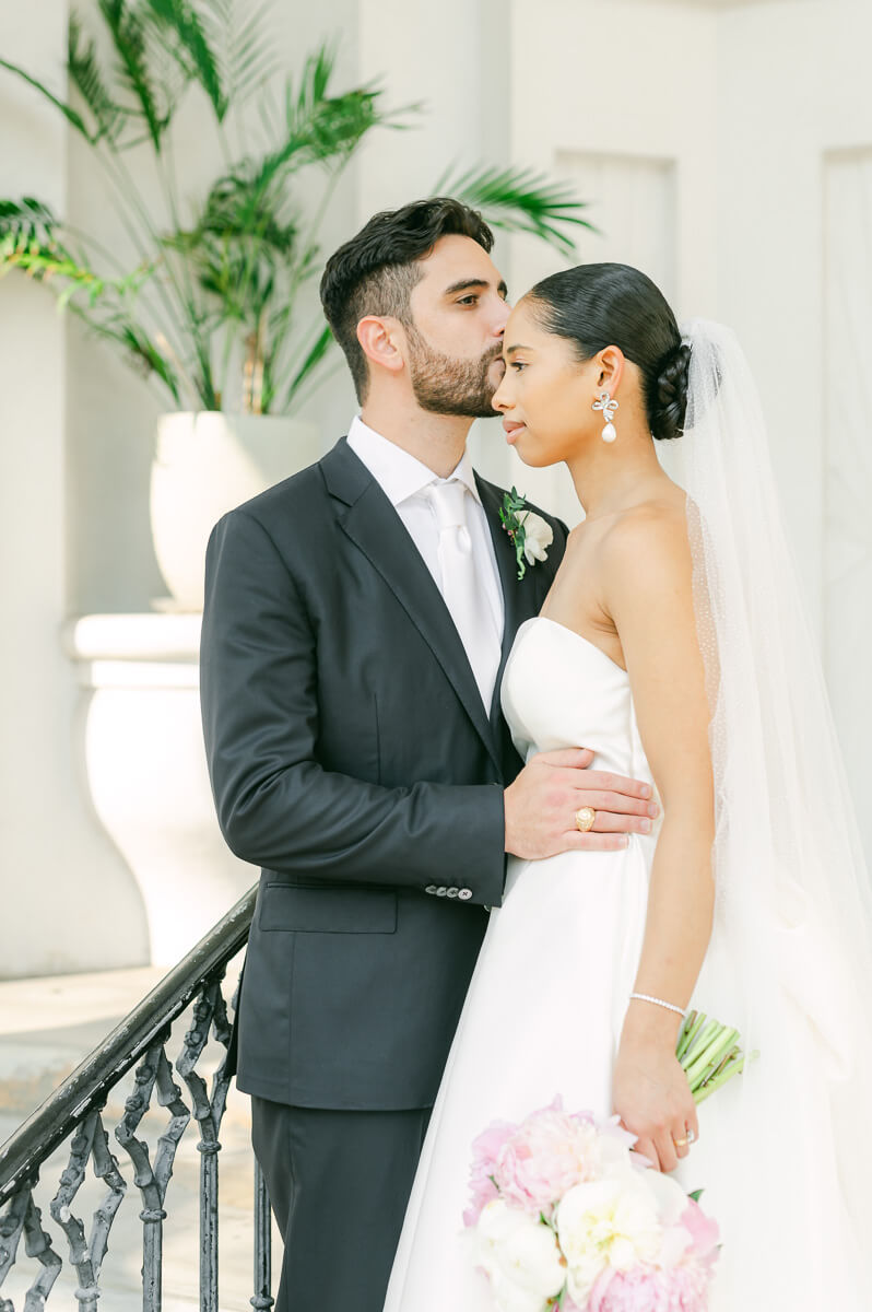 bride and groom posing for Galveston wedding photographer