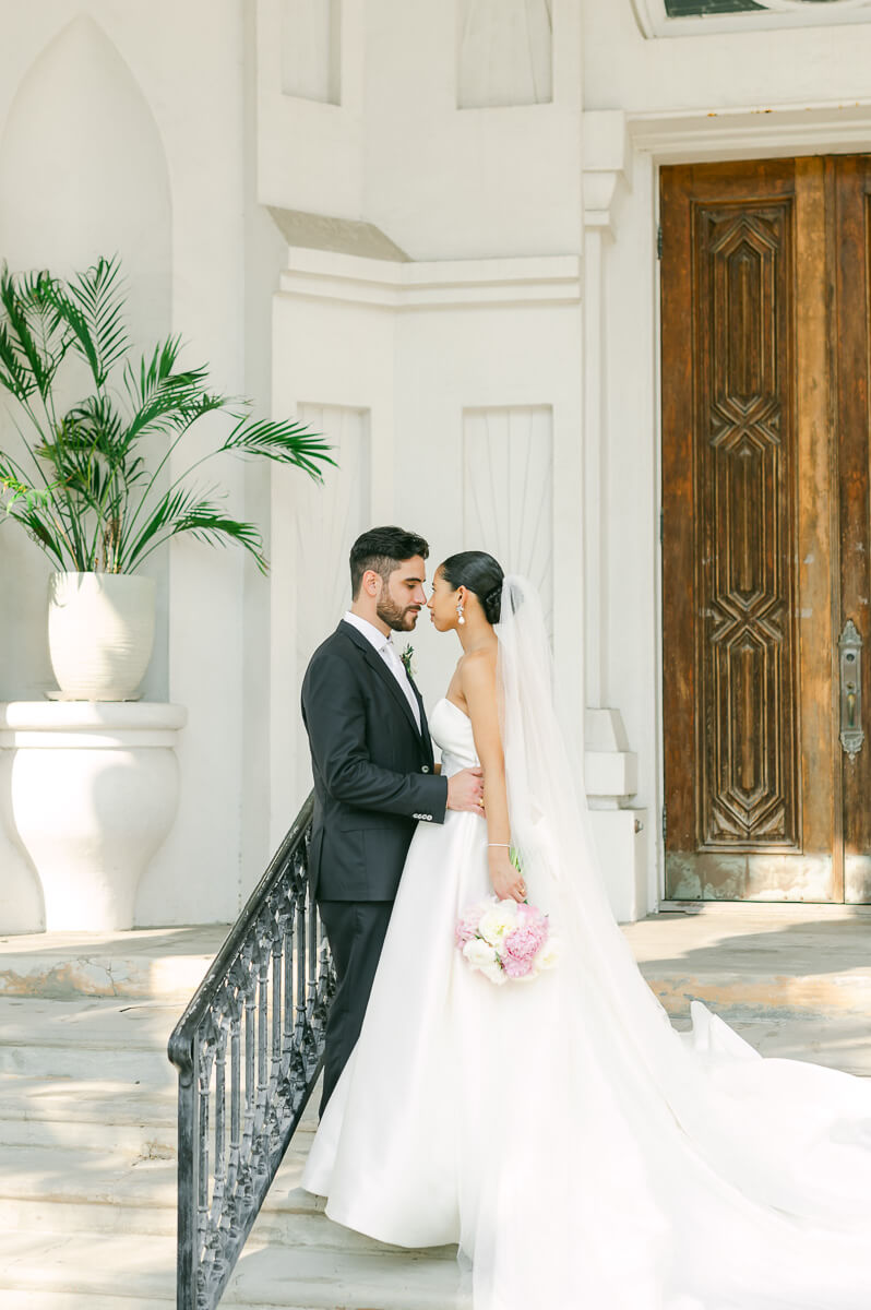 bride and groom posing for Galveston wedding photographer