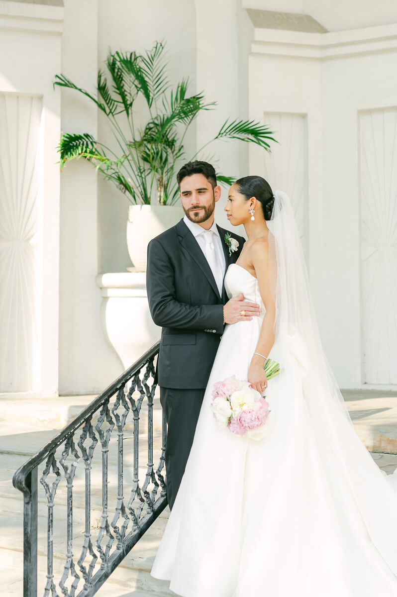 bride and groom posing for Galveston wedding photographer