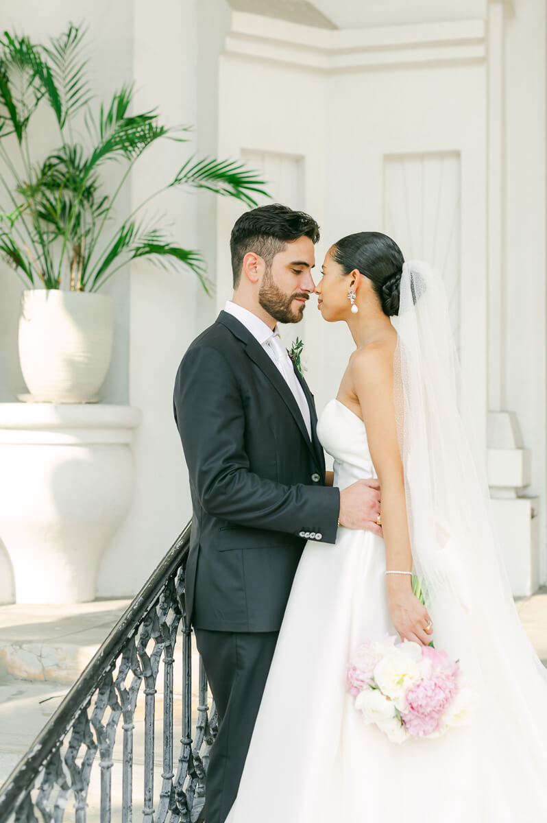 bride and groom posing for Galveston wedding photographer