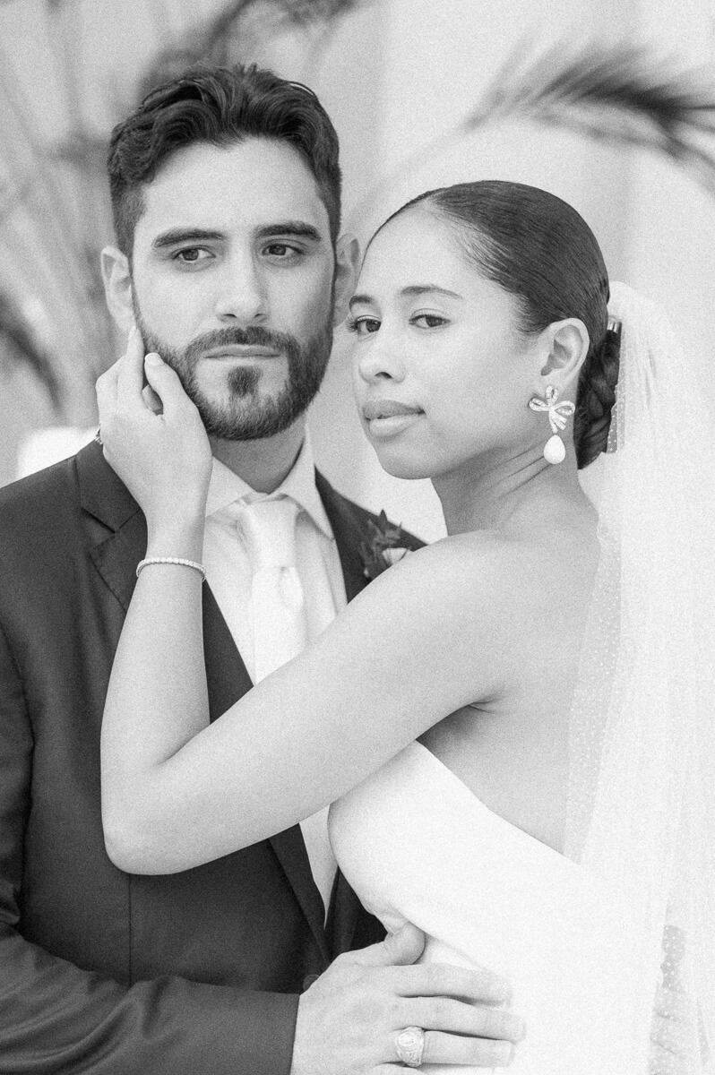 bride and groom posing for Galveston wedding photographer