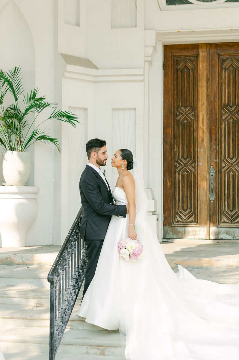 bride and groom posing for Galveston wedding photographer