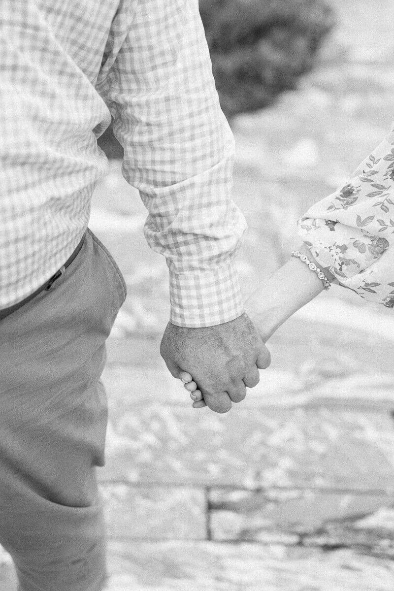 black and white photo of a couple holding hands