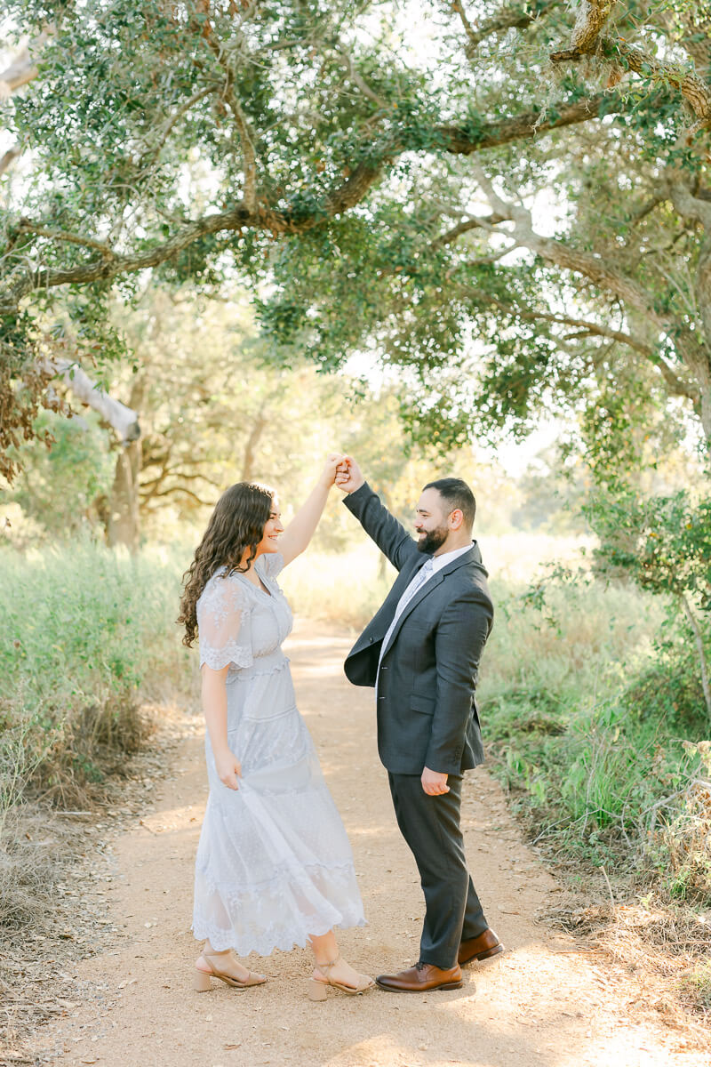 engaged couple dancing at their brazos bend engagement session 