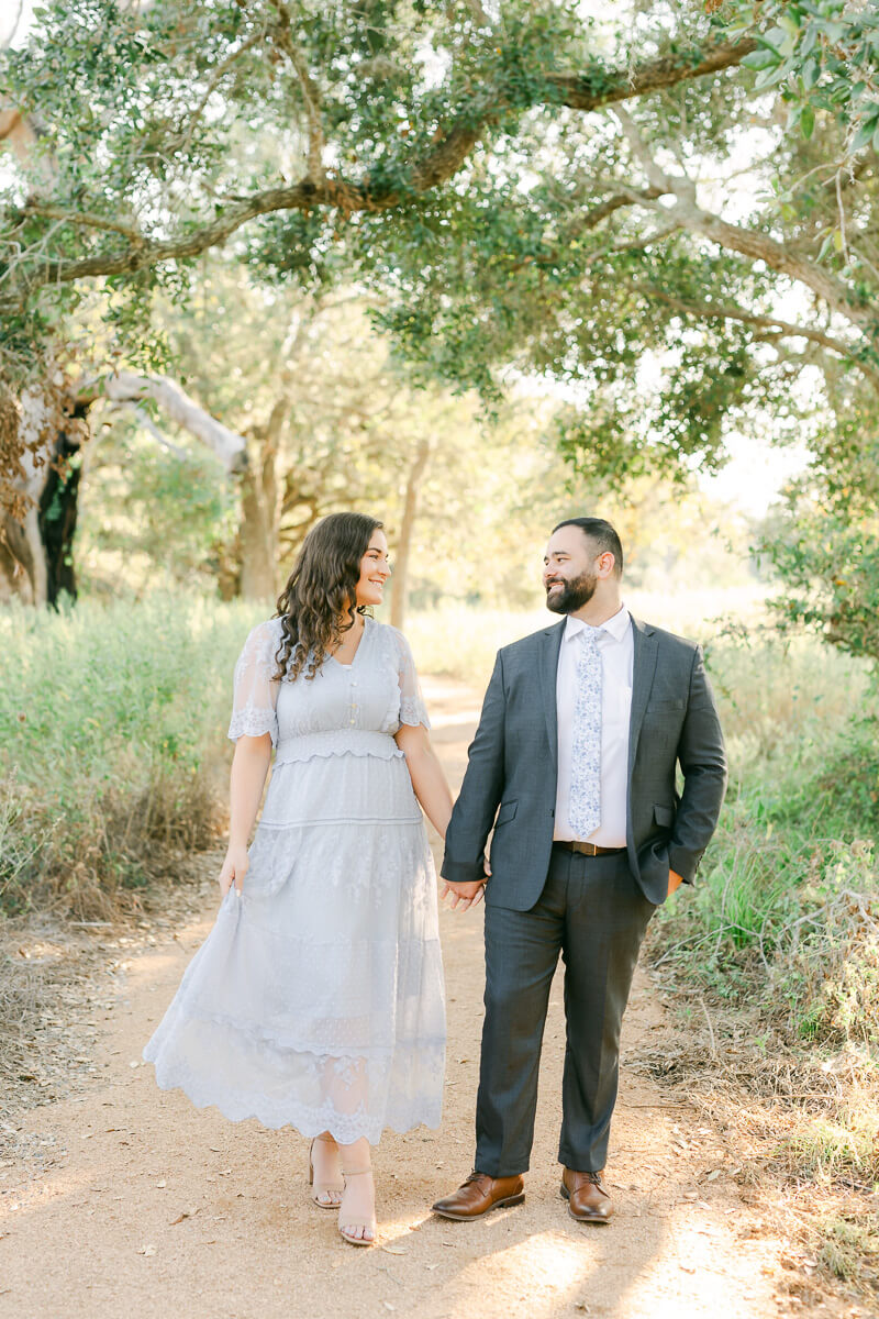 engaged couple walking at their brazos bend engagement session 