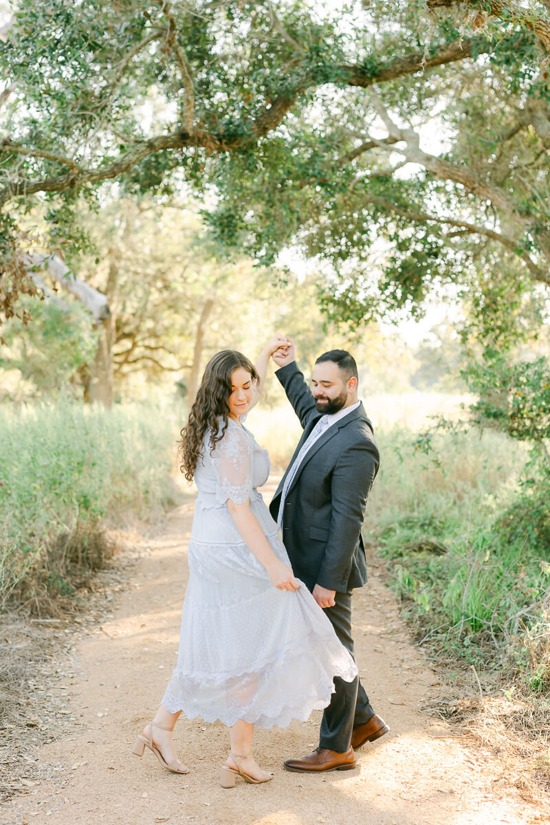 engaged couple dancing at their brazos bend engagement session 