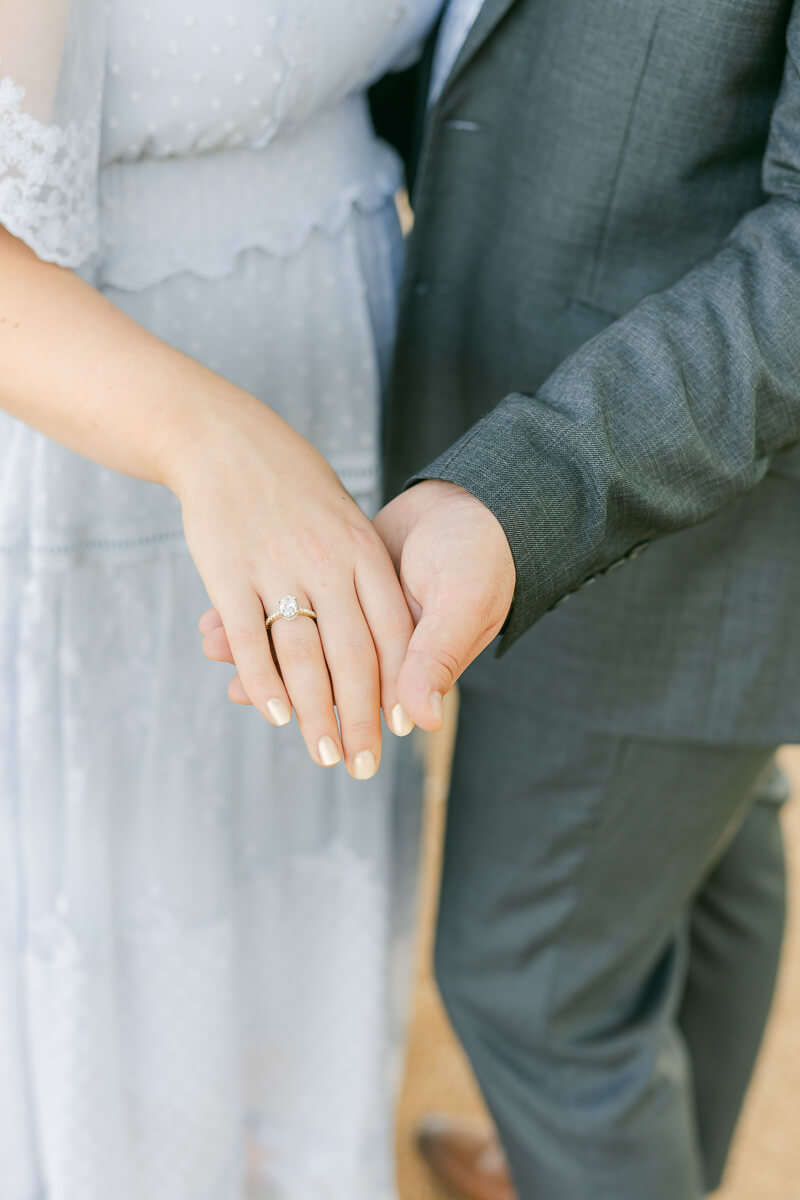 engaged couple showcasing engagement ring