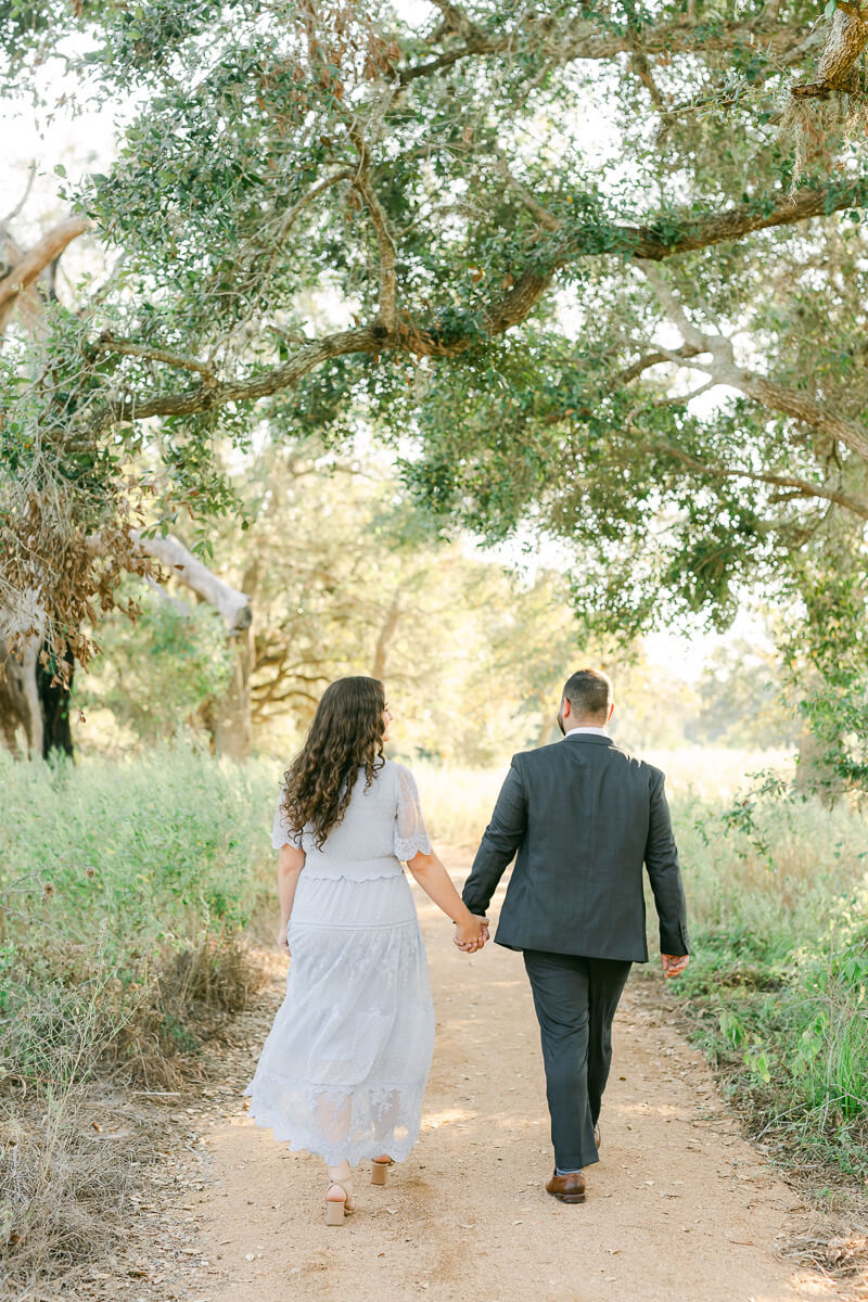 engaged couple walking at their brazos bend engagement session 