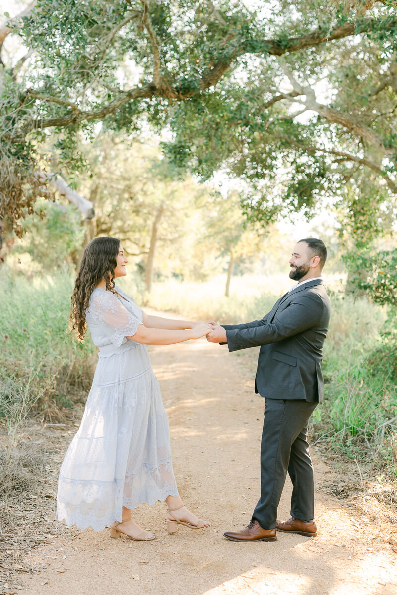 engaged couple dancing at their brazos bend engagement session 