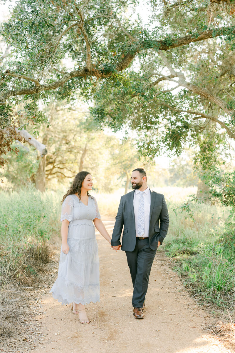 engaged couple walking at their brazos bend engagement session 