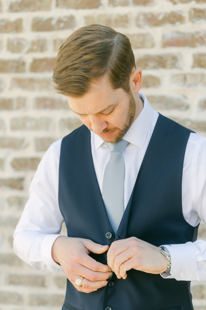 groom getting ready outside Iron Manor wedding venue