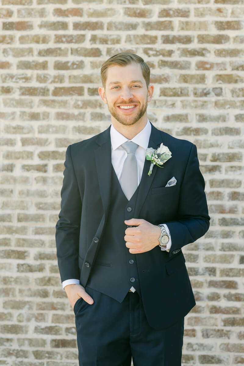 groom posing outside Iron Manor wedding venue