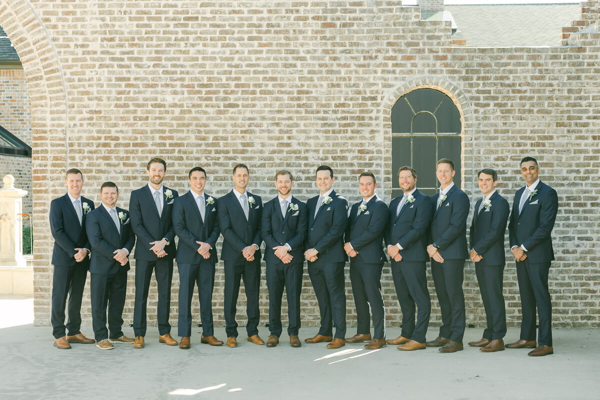 groomsmen in dark blue suits