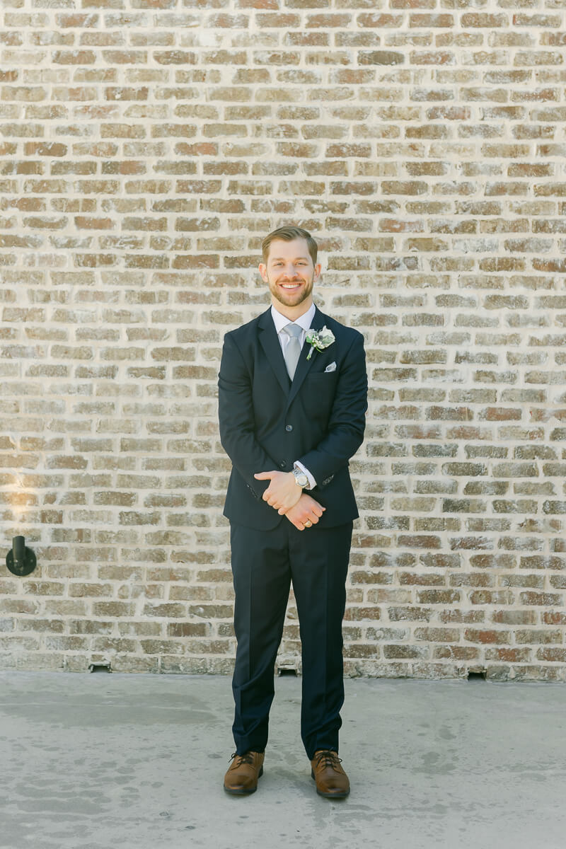 groom posing outside Iron Manor wedding venue