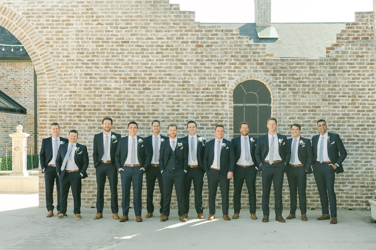 groomsmen in dark blue suits