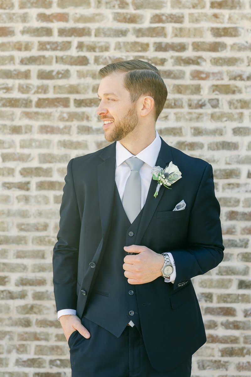 groom posing outside Iron Manor wedding venue