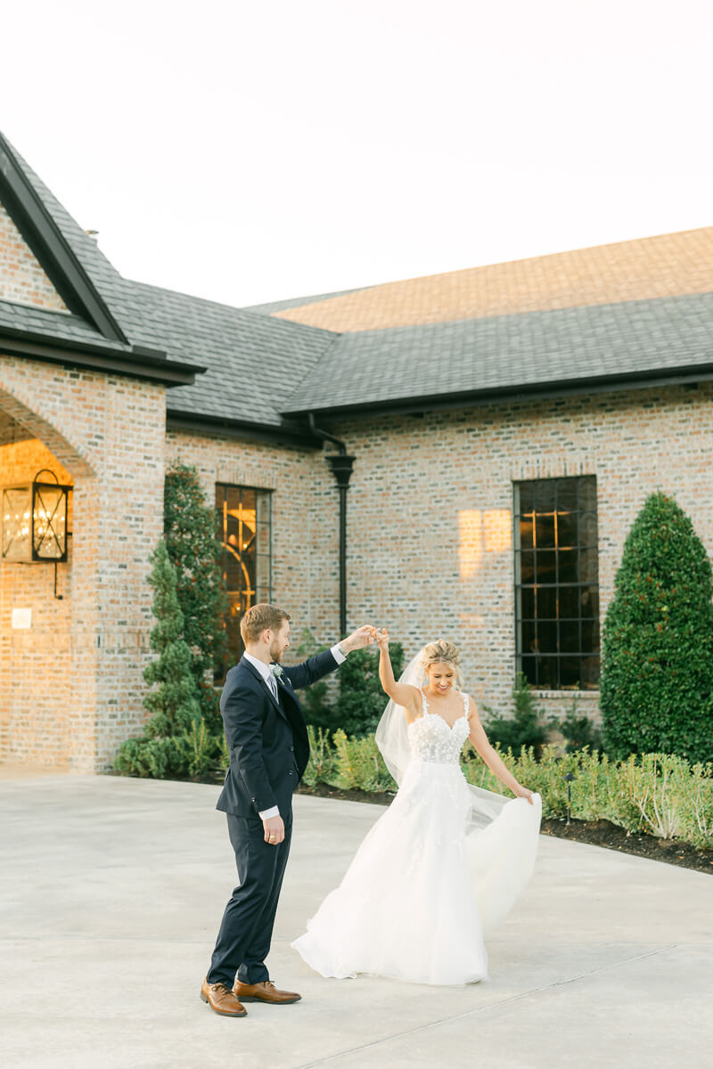 couple dancing in front of Iron Manor wedding venue