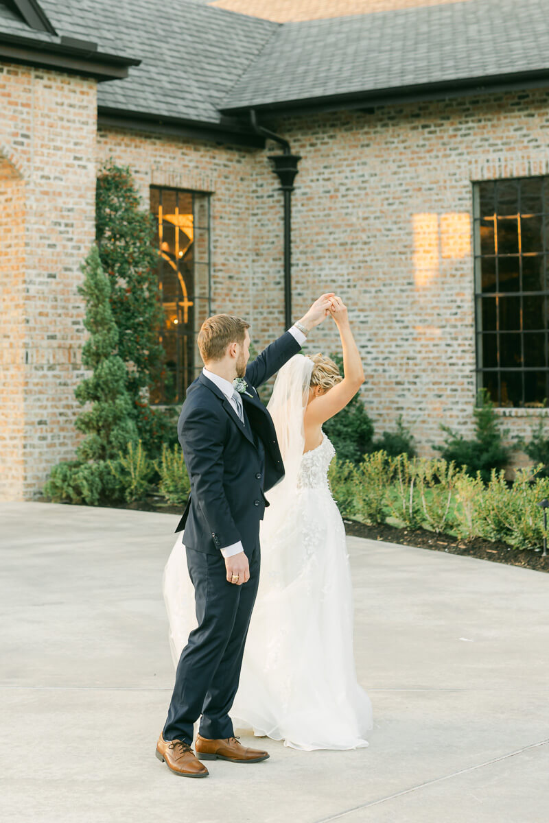 couple dancing in front of Iron Manor wedding venue