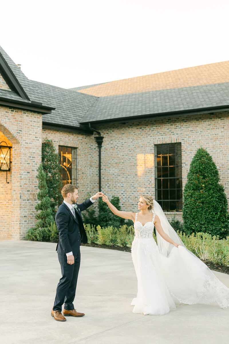 couple dancing in front of Iron Manor wedding venue