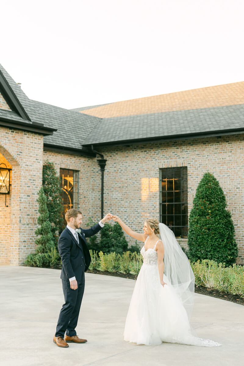 couple dancing in front of Iron Manor wedding venue