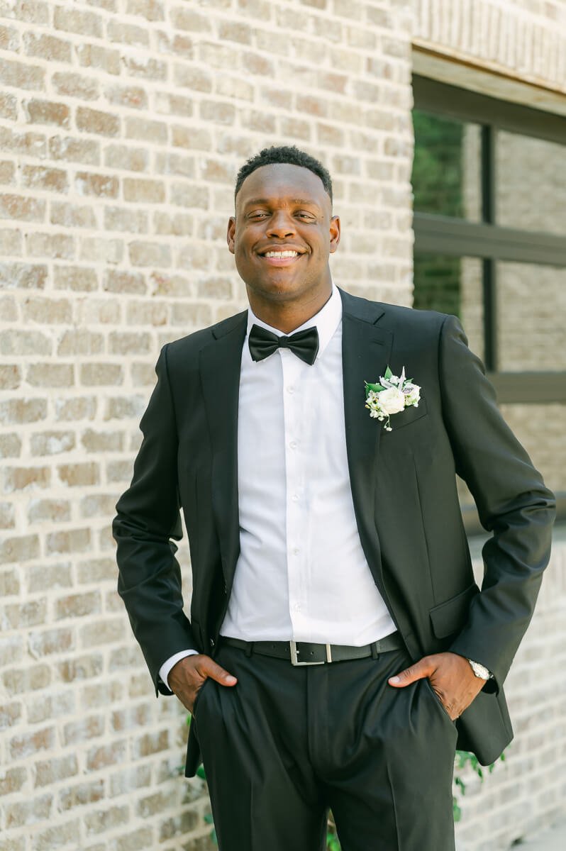 groom posing for Montgomery, Tx wedding photographer 