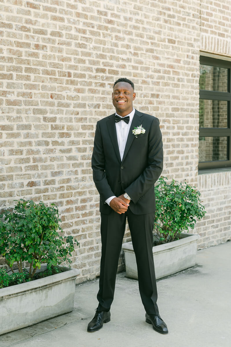 groom posing for Montgomery, Tx wedding photographer 