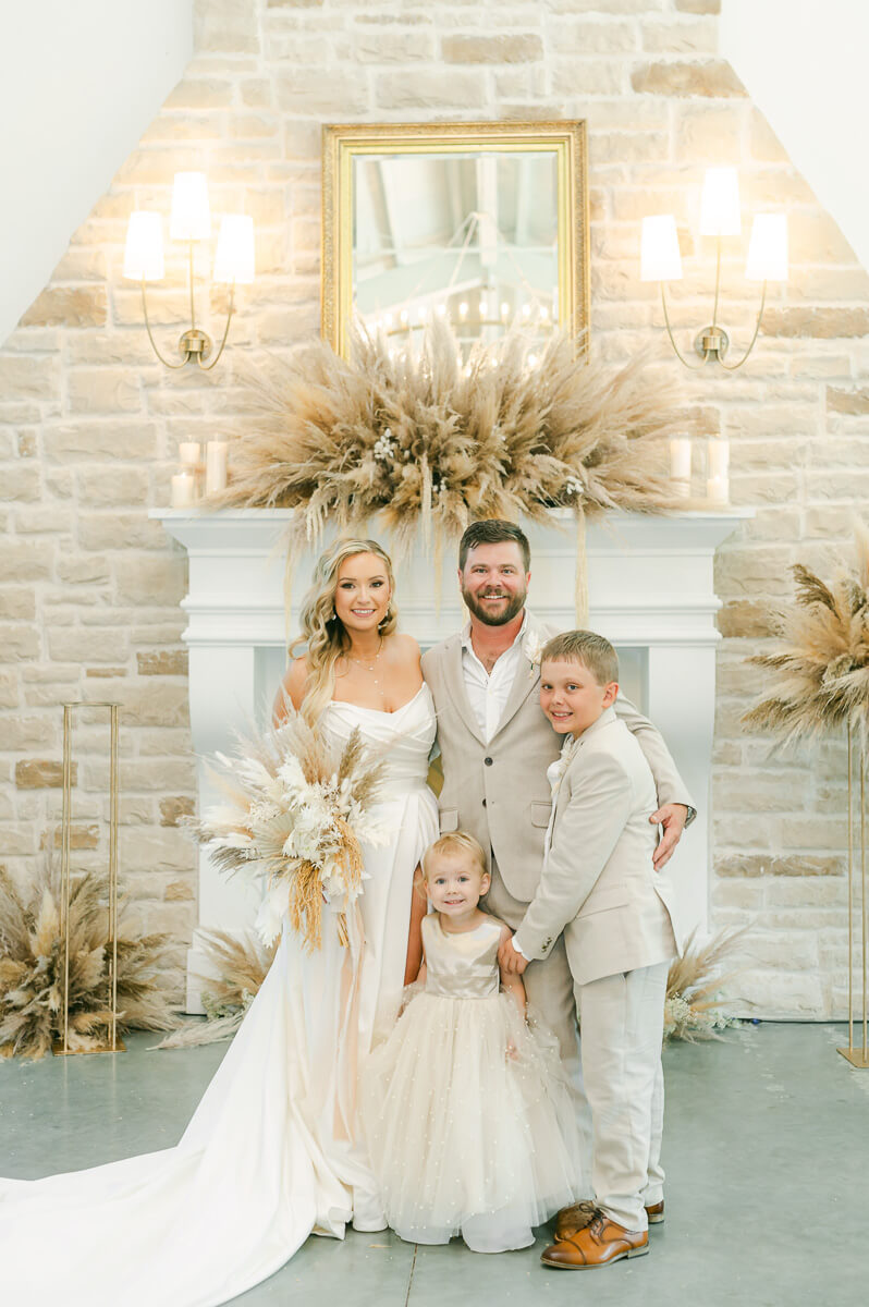 couple with their children on wedding day