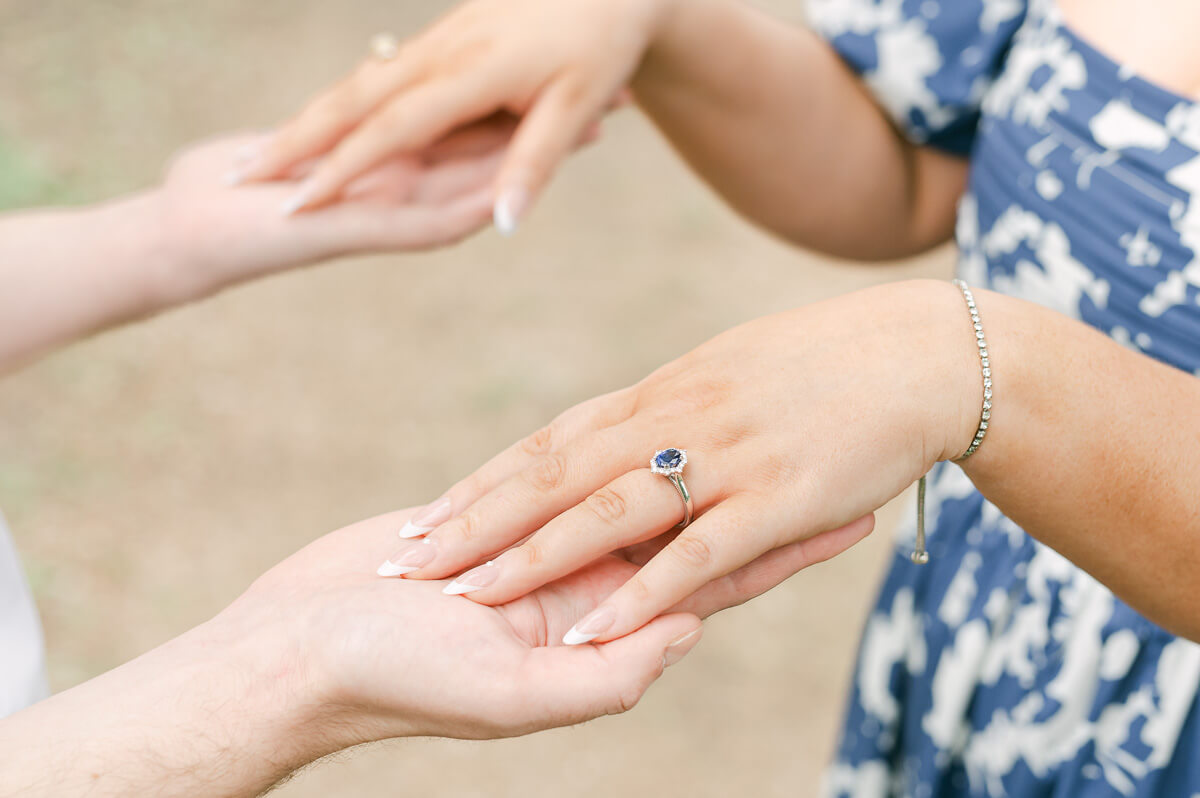 engaged couple showing blue engagement ring