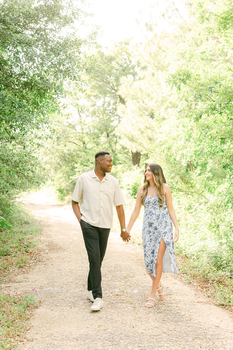 engaged couple walking during Houston engagement session