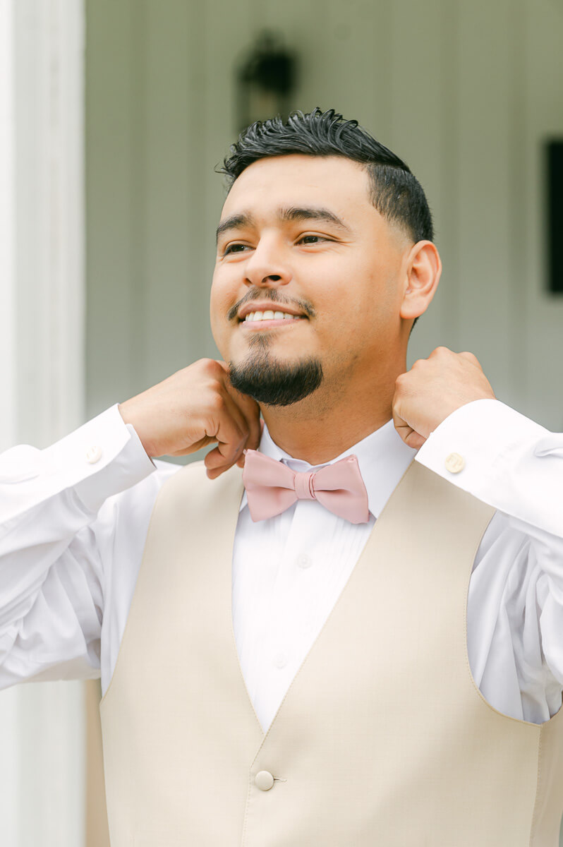 groom getting ready at the farmhouse wedding venue