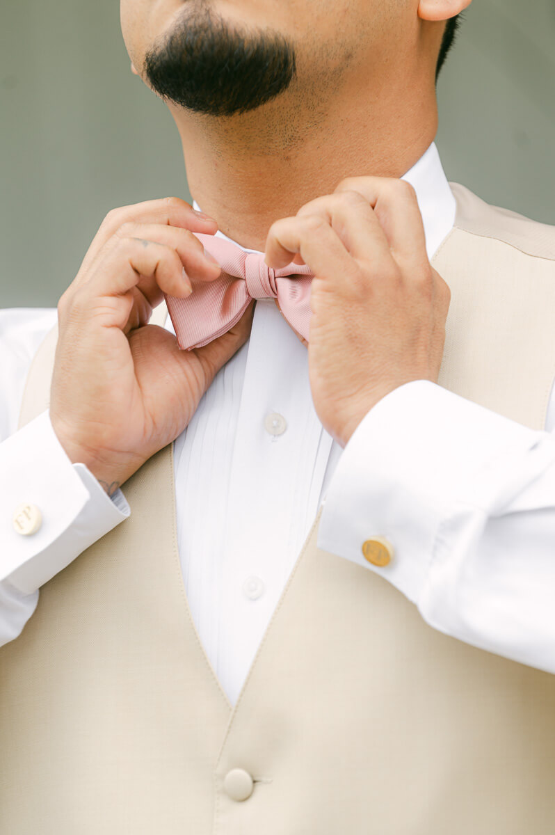 groom getting ready at the farmhouse wedding venue